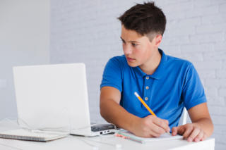 A teenager studying for an exam